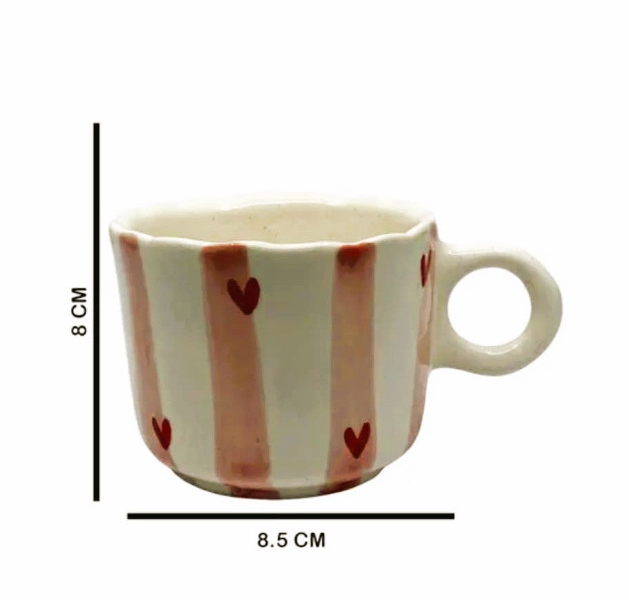 Ceramic mug with heart patterns and measurements on a white background