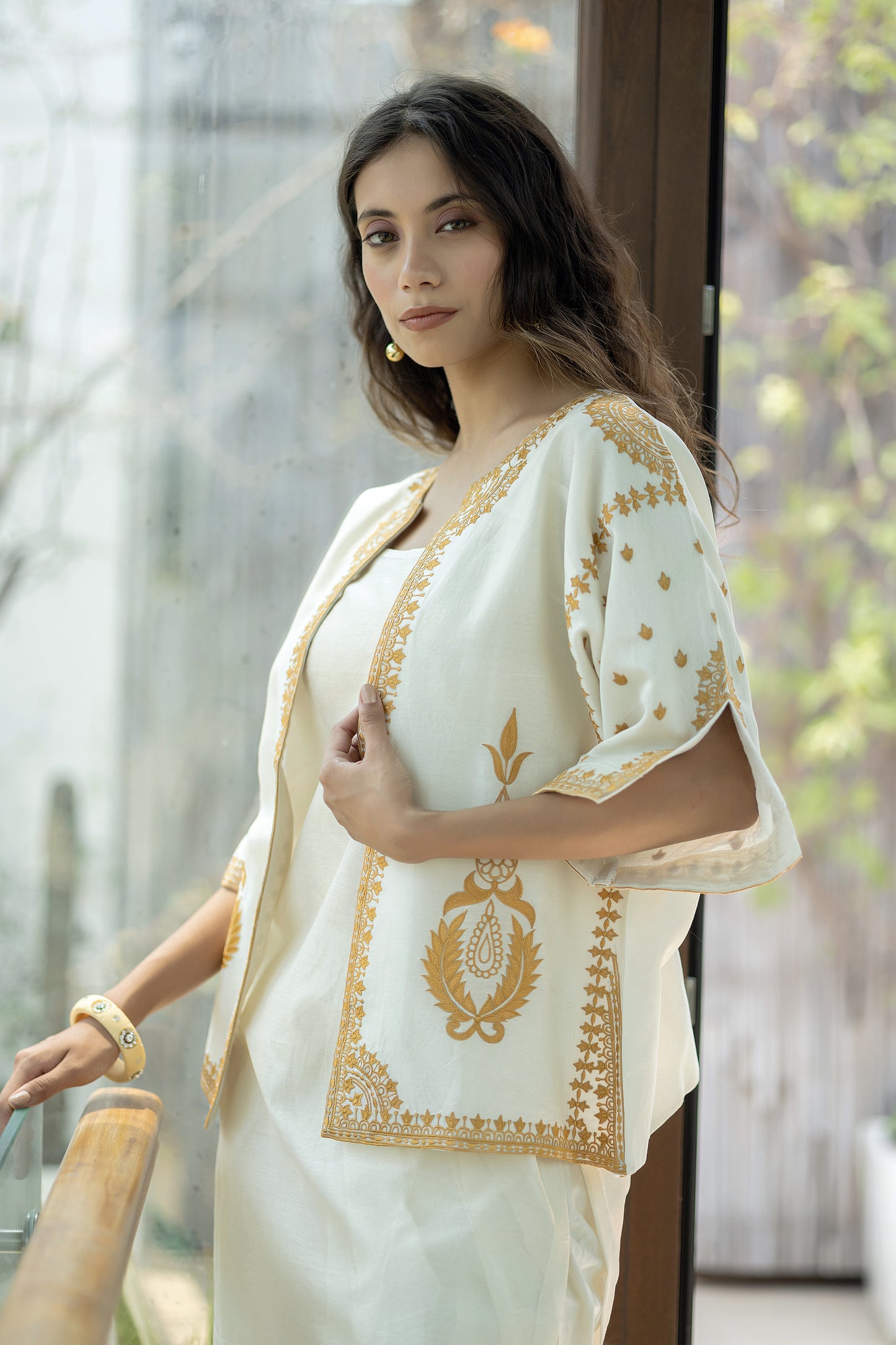 Chanderi sleeveless short kurta paired with embroidered jacket and dhoti pants