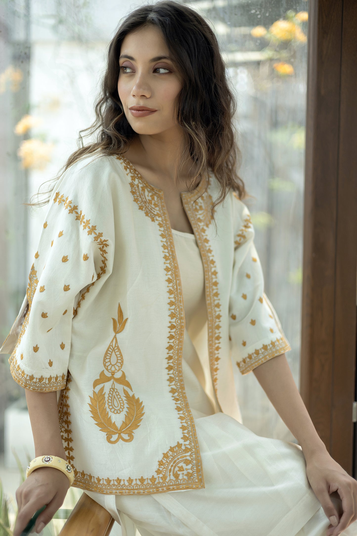 Chanderi sleeveless short kurta paired with embroidered jacket and dhoti pants
