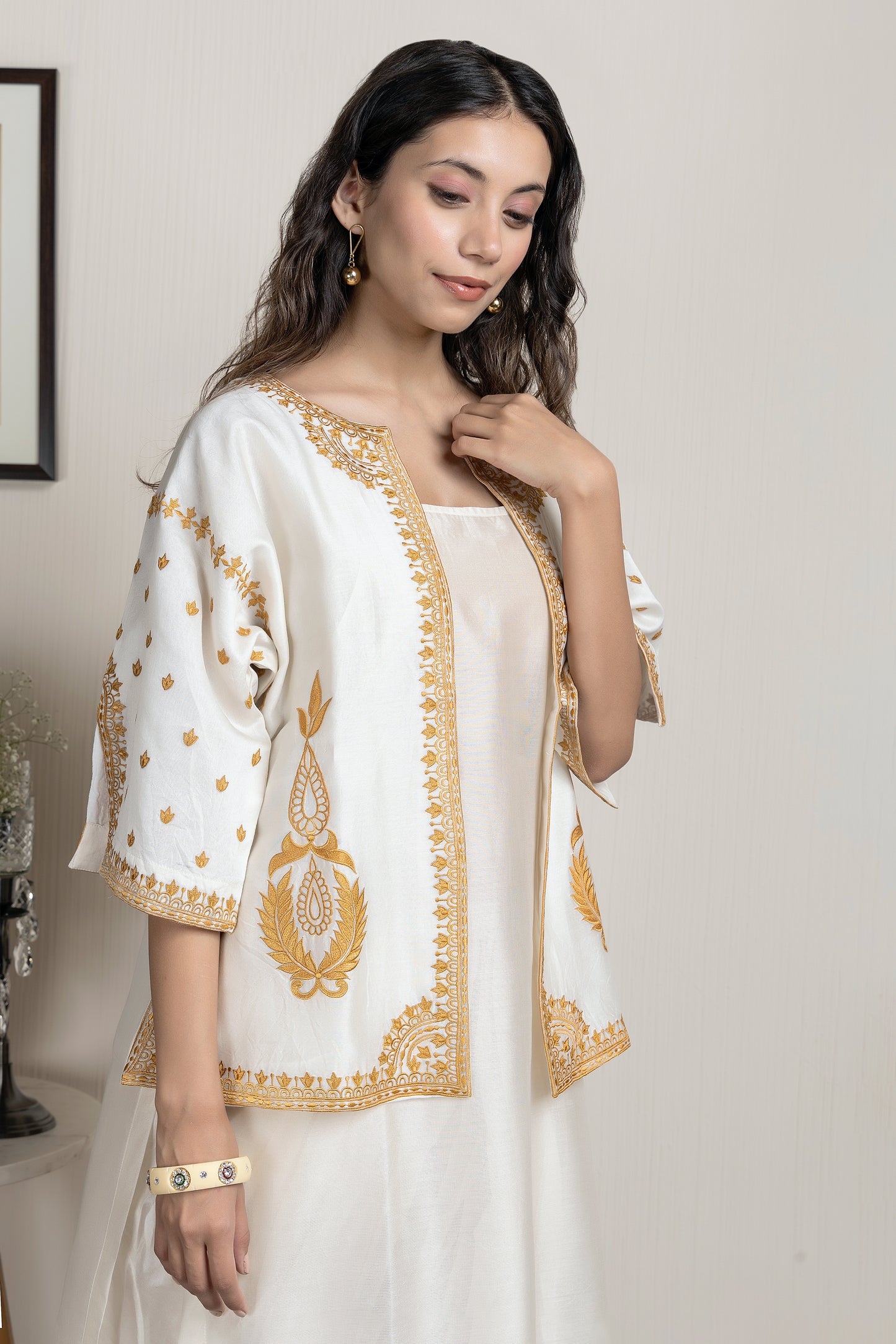 Chanderi sleeveless short kurta paired with embroidered jacket and dhoti pants