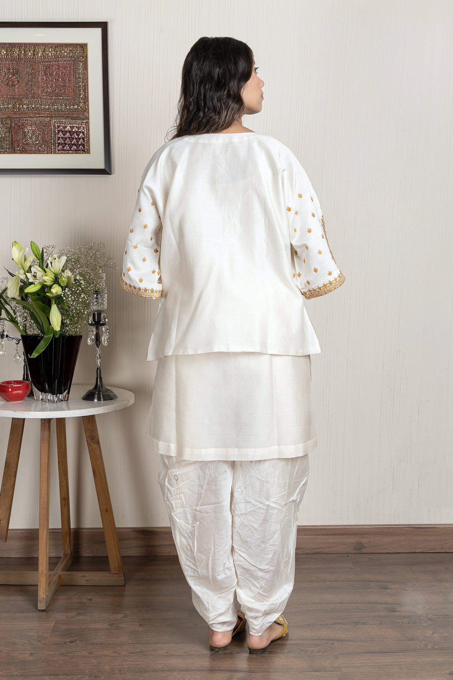 Chanderi sleeveless short kurta paired with embroidered jacket and dhoti pants