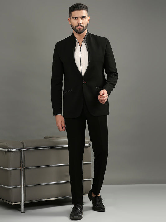Featuring a black tuxedo featuring a high neck & satin accents, paired with black formal pants - perfect for black-tie events or gala dinners.
