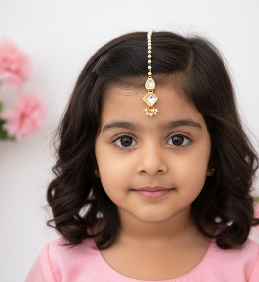 Small Kundan white tikka worn by girl
