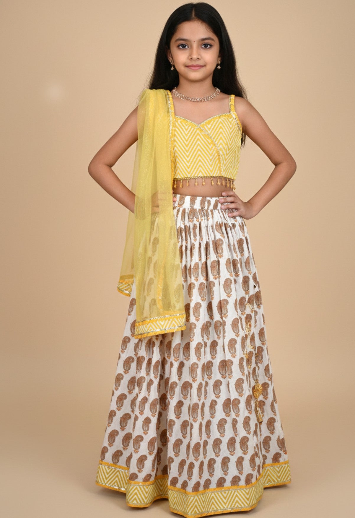 Yellow paisley lehenga with zig zag blouse and net dupatta
